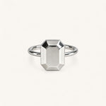 Jennifer Loiselle silver geometric ring featuring a faceted emerald  metal stone.