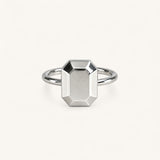 Jennifer Loiselle silver geometric ring featuring a faceted emerald  metal stone.