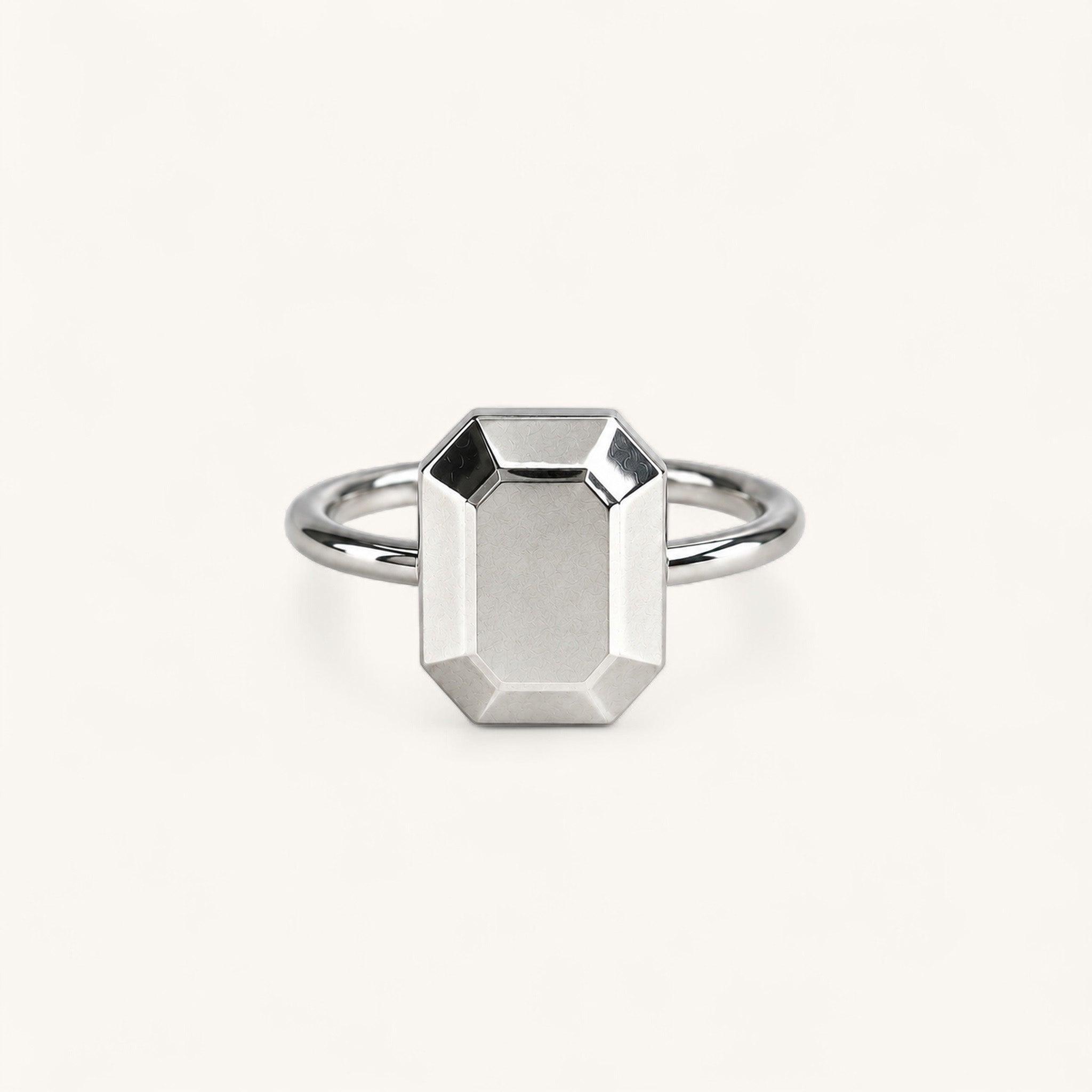 Jennifer Loiselle silver geometric ring featuring a faceted emerald  metal stone.