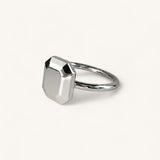 Jennifer Loiselle silver geometric ring featuring a faceted emerald  metal stone.