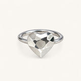 A silver ring featuring a faceted, heart-shaped centerpiece by Jennifer Loiselle