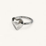 A silver ring featuring a faceted, heart-shaped centerpiece by Jennifer Loiselle