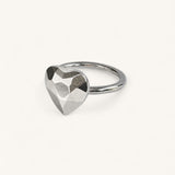 A silver ring featuring a faceted, heart-shaped centerpiece by Jennifer Loiselle