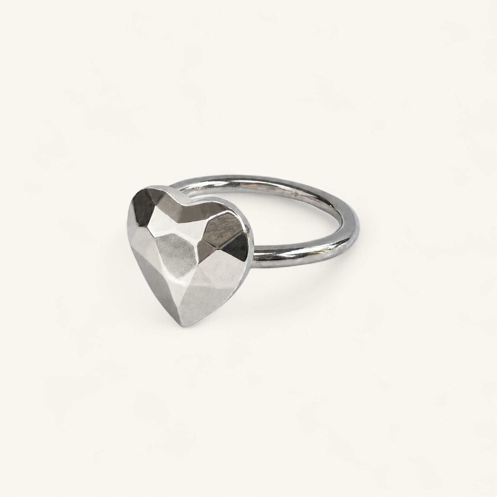 A silver ring featuring a faceted, heart-shaped centerpiece by Jennifer Loiselle