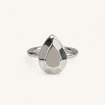 A silver ring featuring a faceted, pear-shaped metal top, handmade in London by Jennifer Loiselle 