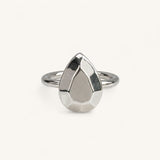 A silver ring featuring a faceted, pear-shaped metal top, handmade in London by Jennifer Loiselle 