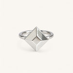 A Jennifer Loiselle silver geometric ring featuring a faceted princess-cut centerpiece with a polished band.